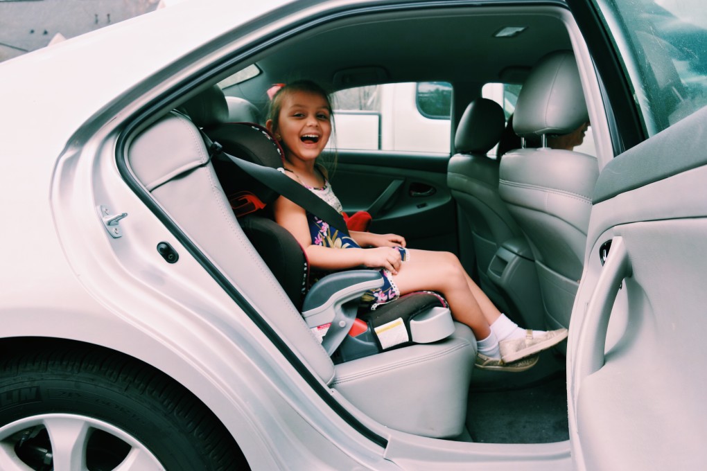 What is the safest way for a child to travel in a car
